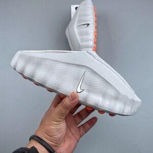 Nike White Slip-On Golf Shoes with Orange Studs and Silver Swoosh